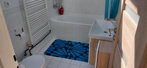 a bathroom with a toilet and a blue shower rug at Apartmán Hodoňovice in Frýdek-Místek