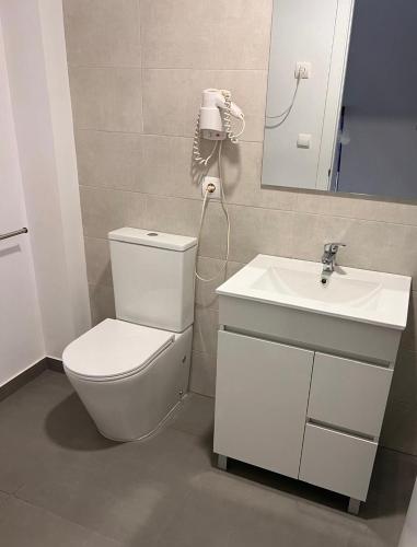 a bathroom with a toilet and a sink at Apartamentos Portinatx Sea View in Portinatx