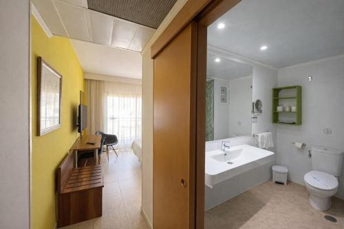 a bathroom with a tub and a toilet and a sink at Prince Park in Benidorm