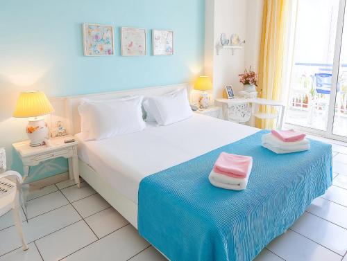 a bedroom with a bed with two towels on it at Hotiday Vico Equense in Vico Equense