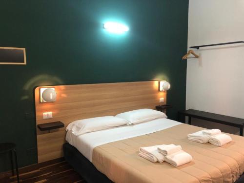 a bedroom with a large bed with towels on it at Il Piccolo Albergo Matera in Matera