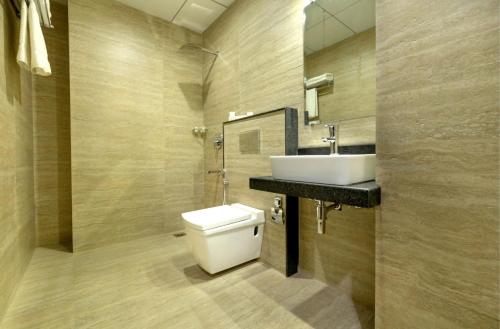 a bathroom with a toilet and a sink at The Livin-Bani Park in Jaipur