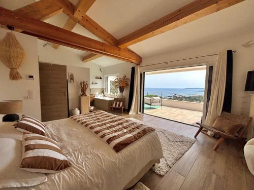 a bedroom with a large bed and a large window at Villa Horizon Bleu in Sainte-Maxime