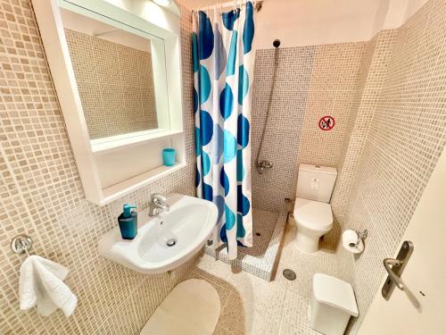 a bathroom with a sink and a toilet and a shower at FLY, Oneiropagida, Aegina in Vathí