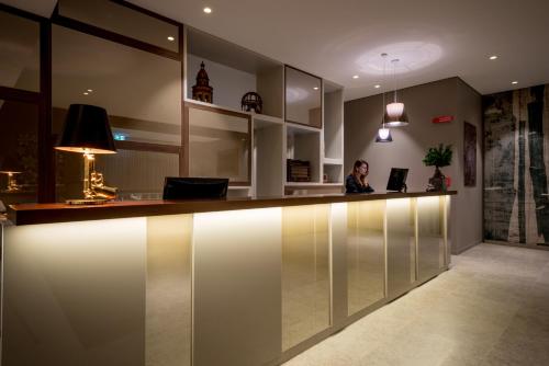 a woman sitting at a reception counter in a room at Fuori le Mura in Altamura