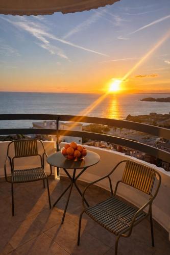 a balcony with a table and chairs and a sunset at Casa Ivo OceanView in Portimão