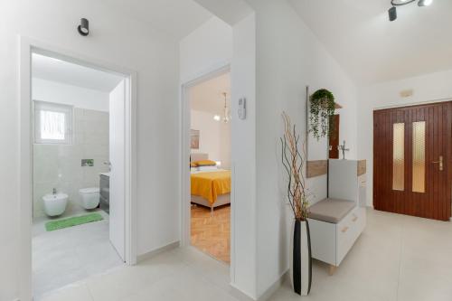 a white room with a bedroom with a bed at House FELICIA in Kršan