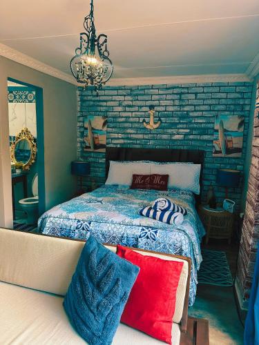 a bedroom with a bed and a brick wall at Ocean gate in Hartbeespoort