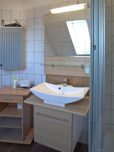 a bathroom with a sink and a mirror at Hotel Zum Wersehof in Ahlen