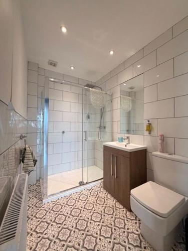 a bathroom with a shower and a toilet and a sink at Stay in Blackpool