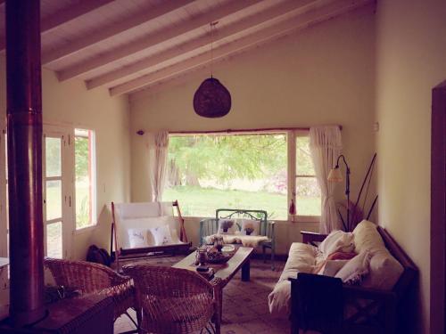 a living room with a couch and a table at Finca El Encuentro in Campana