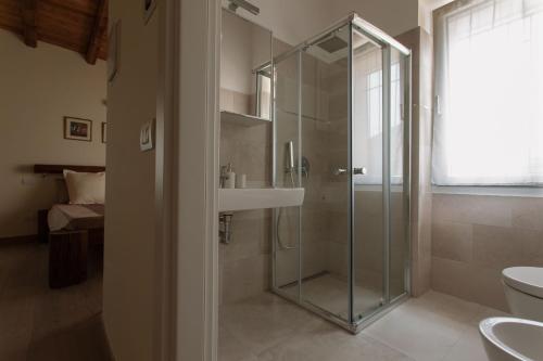 a bathroom with a glass shower and a sink at Cascina San Martino in Passirano