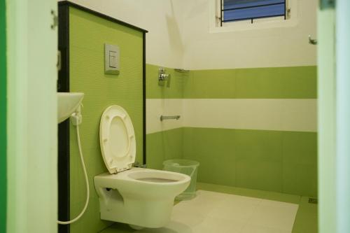 a bathroom with a toilet and a sink at The Glen By Bloobuck in Ambalavayal
