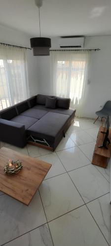 a living room with a couch and a table at Dafnonas House - Bright & Modern in Leonidio