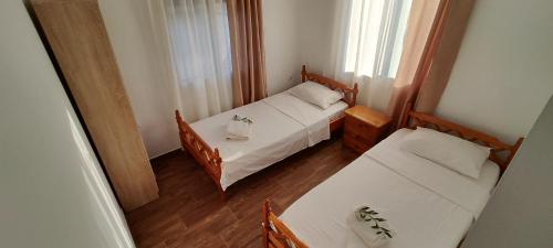 a small room with two beds and a window at Dafnonas House - Bright & Modern in Leonidio