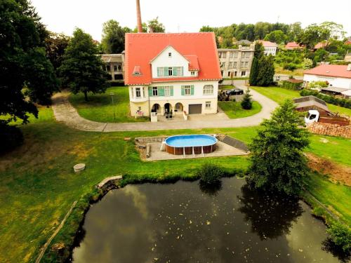 an aerial view of a house with a pond at Penzion Jungmannova in Šluknov