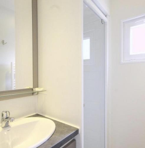a bathroom with a sink and a mirror at TI WAR AN DOUR in Guégon