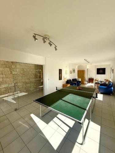 a living room with a ping pong table in it at Polis Gardens Pool Apartment in Polis Chrysochous