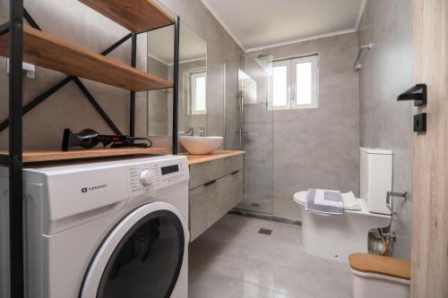 a washing machine in a bathroom with a sink at Villa Pasiphae by PosarelliVillas in Vamos