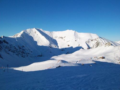 a mountain covered in snow with people skiing on it at Gästehaus Flörl in Gerlosberg