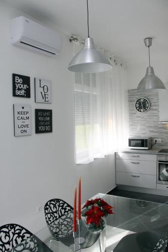a kitchen with a glass table and two chairs at Ka Star in Karlovac