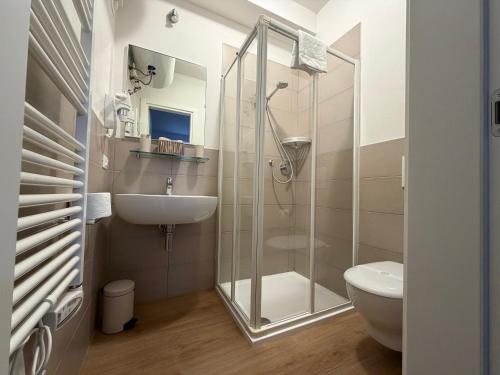 a bathroom with a shower and a sink and a toilet at Corte Al Lago in Moniga