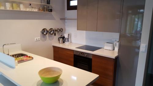 a kitchen with a counter with a sink and a refrigerator at Casa Veran at La Finca Golf in Algorfa