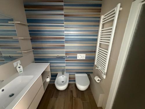 a bathroom with two toilets and a sink at Vale House in Monopoli