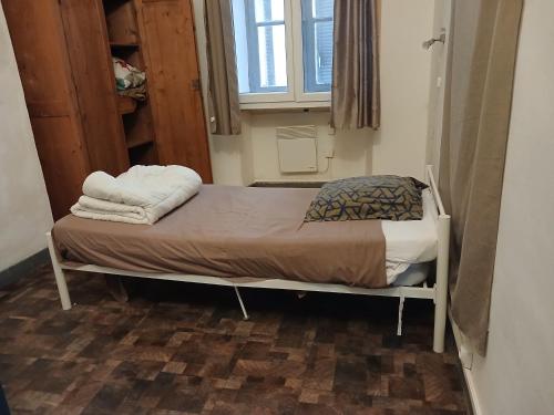 a small bed in a room with a window at Massilia in Marseille