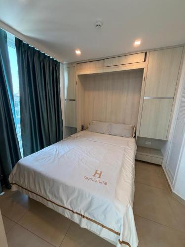 a bedroom with a large bed in a room at City Garden Olympus Premier By Vacation Vibes in Pattaya South