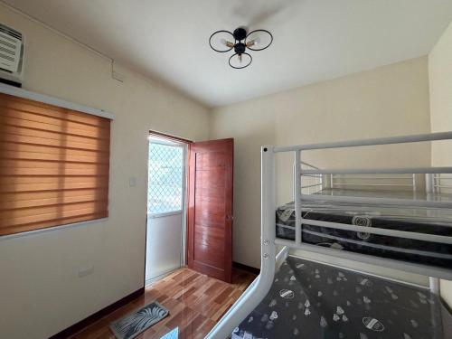 a bedroom with a bunk bed and a window at Amad's Rental Space Family Room in Bantayan Island