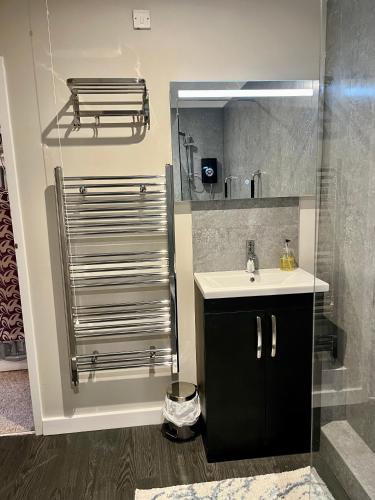 a bathroom with a sink and a shower at Casa di Qeis a double bedroom ground floor flat with free parking in Chesterton