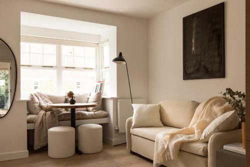a living room with a couch and a table at Bright Japandi 1BR Flat with Garden - Central Oxford in Oxford
