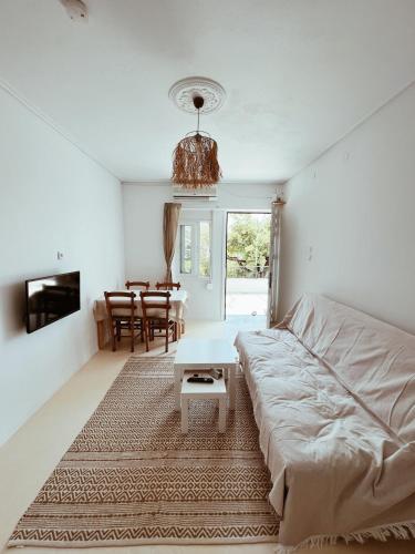 a living room with a bed and a table at Sand & Sea II in Neo Klima