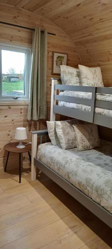 a bedroom with a bunk bed in a cabin at Stag's View in Ballina