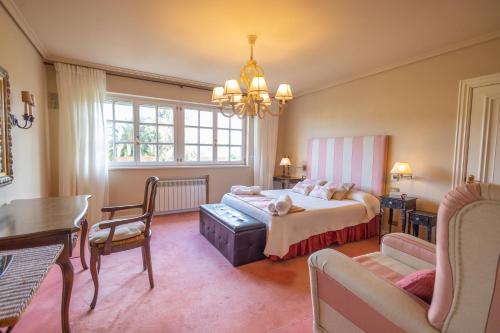 a bedroom with a bed and a couch and a table at Villa familiar - Jacuzzi - Children's Area in Bacoy