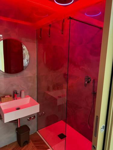 a red bathroom with a sink and a shower at B&B Capo Rizzuto Armenes in Capo Rizzuto