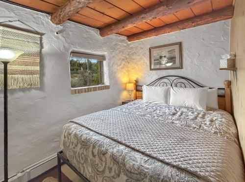 a bedroom with a bed and a window at Casita Adobe in Grand Junction