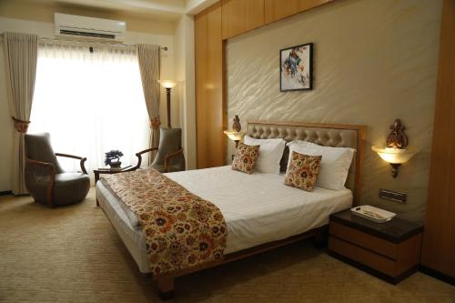 a hotel room with a bed and a window at Hotel Jannat Celebration in Wani