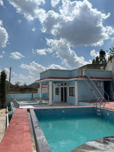 a house with a swimming pool in front of it at The Celestine Villa in Thūr