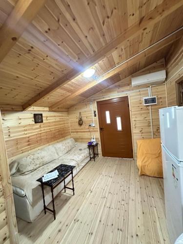 a room with a couch and a refrigerator in a room at Guesthouse Katerina in Përmet