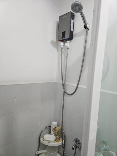 a shower in a bathroom with a toilet at Leina Life-Style Comfy Studio Balcony near Mactan Airport in Bankal