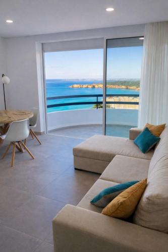 a living room with a couch and a view of the ocean at Casa Ivo OceanView in Portimão
