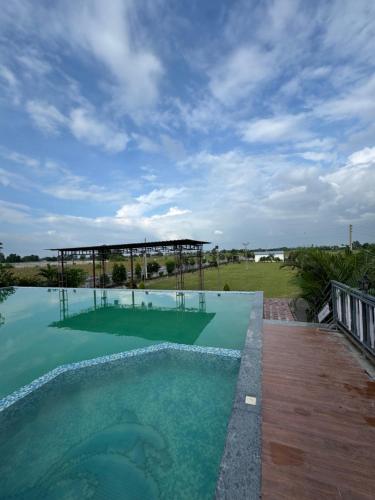 a large swimming pool with a clear blue water at Infinity farm and garden in Bhopal