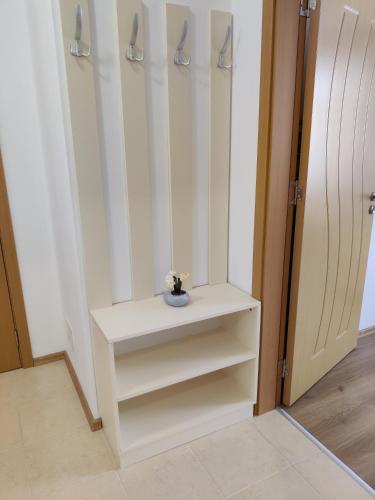 a room with a white cabinet with a vase on it at Villa Rossa in Ravda