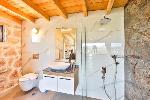 a bathroom with a shower and a sink and a toilet at Patara breeze in Kaş