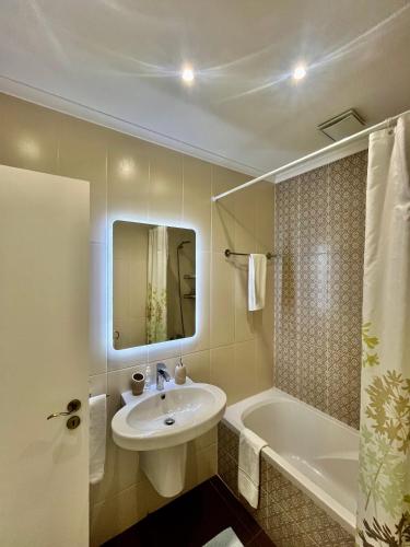 a bathroom with a sink and a bath tub at Paradise in Costa da Caparica