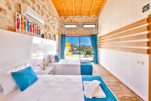 a bedroom with two beds and a window at Patara breeze in Kaş