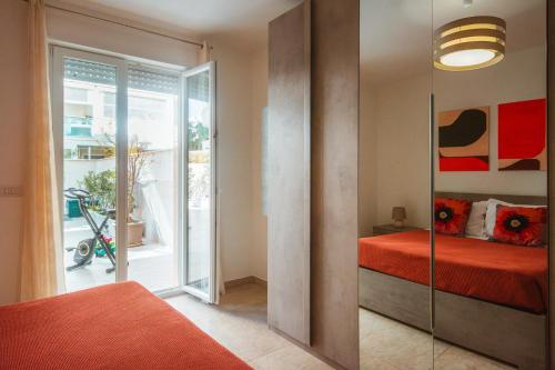 a bedroom with a bed and a glass door at Velaria Boutique Apartment in Monopoli