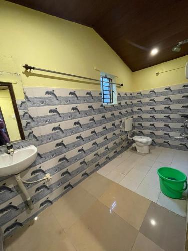 a bathroom with a flock of birds on the wall at Gokarna Beach Vibes in Gokarn
